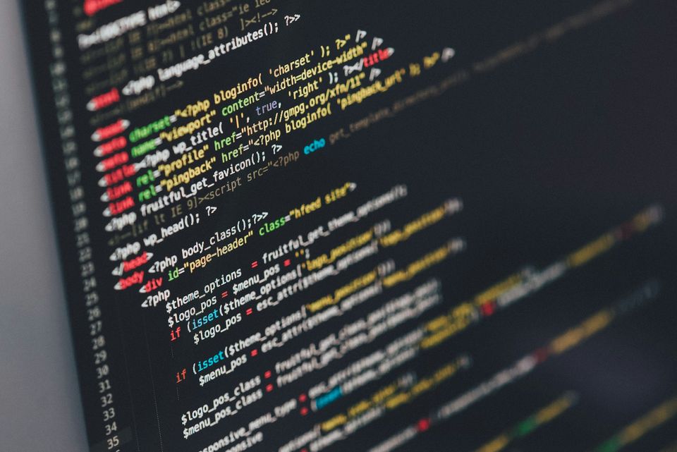 Close-up of HTML and PHP code on a dark computer screen
